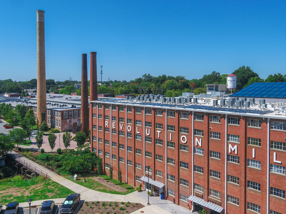 an aerial image of the southern facade of a recently restored mill building.